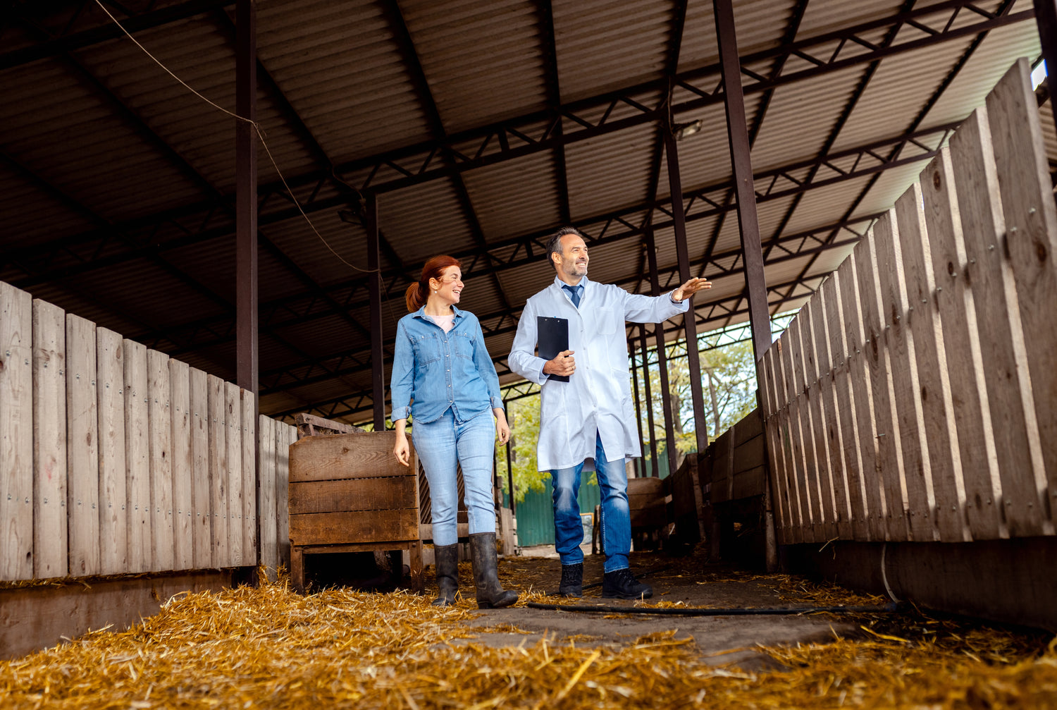 man in lab coat and woman in barn
